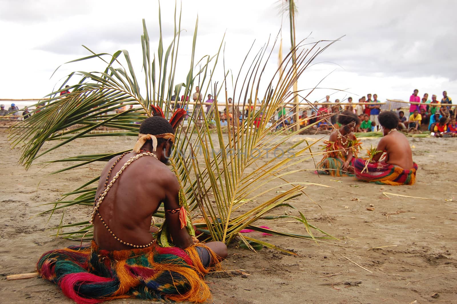 People sit on sand, mask festival, Papua New Guinea