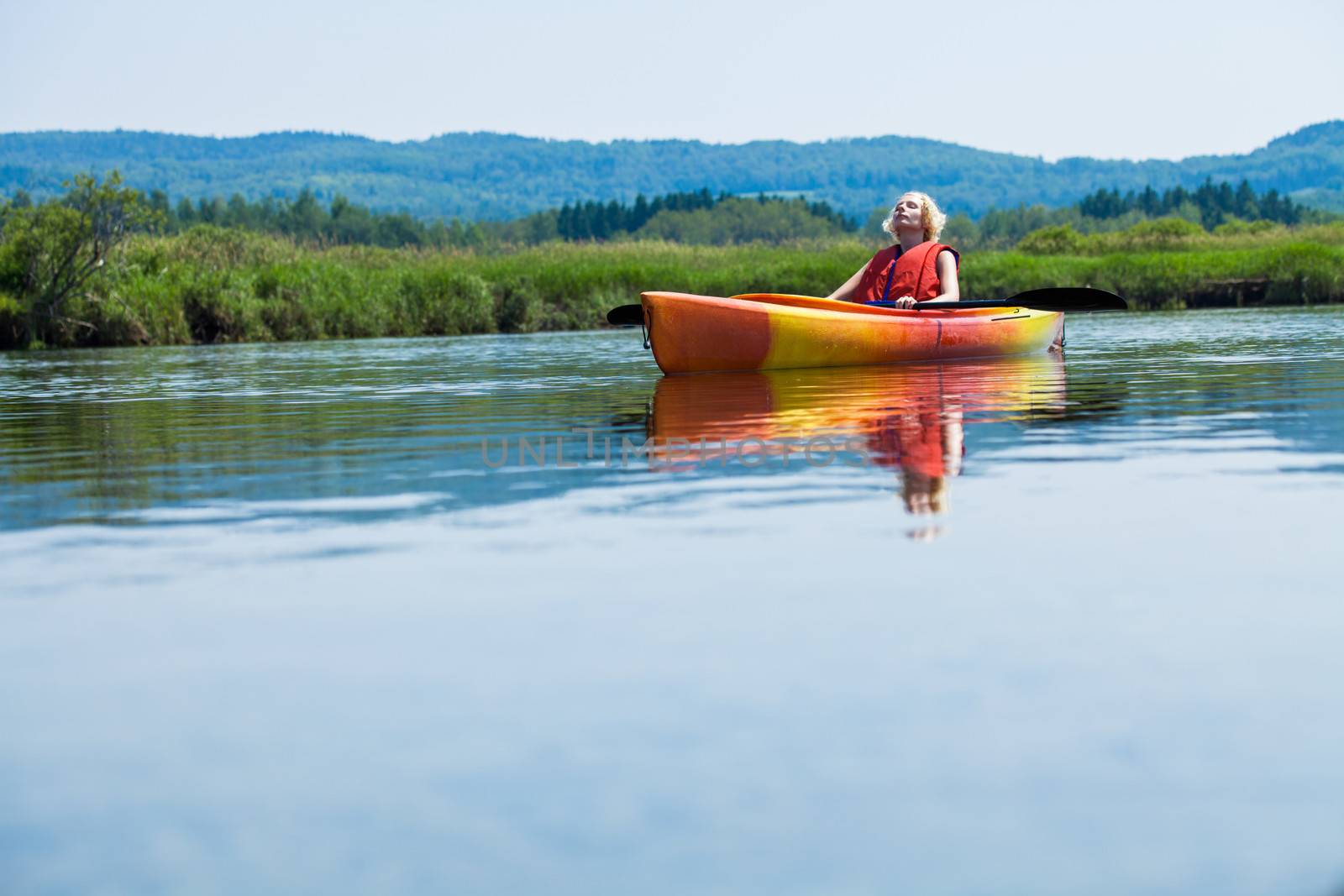 Woman Relaxing on a Kayak and Enjoying her Life by aetb