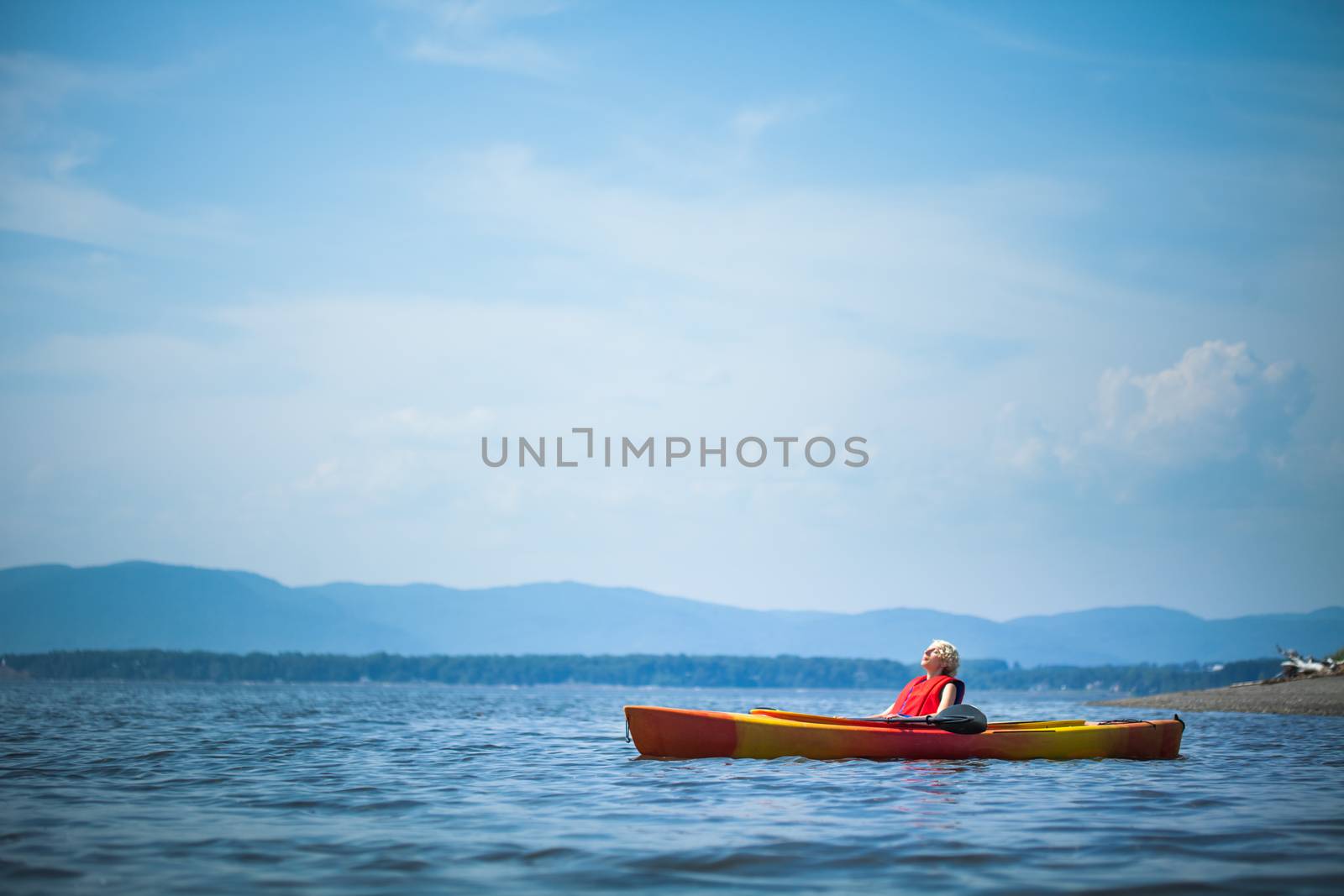 Young Woman Relaxing on a Kayak and Enjoying the Moment of Freedom