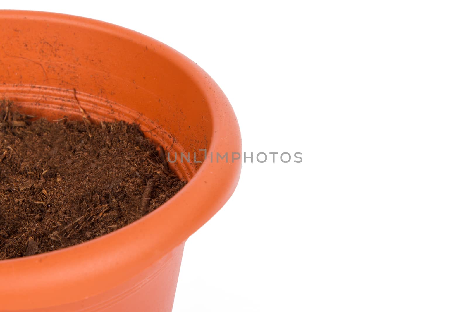 Detail view of flower pot and full of soil, isolated on white background.