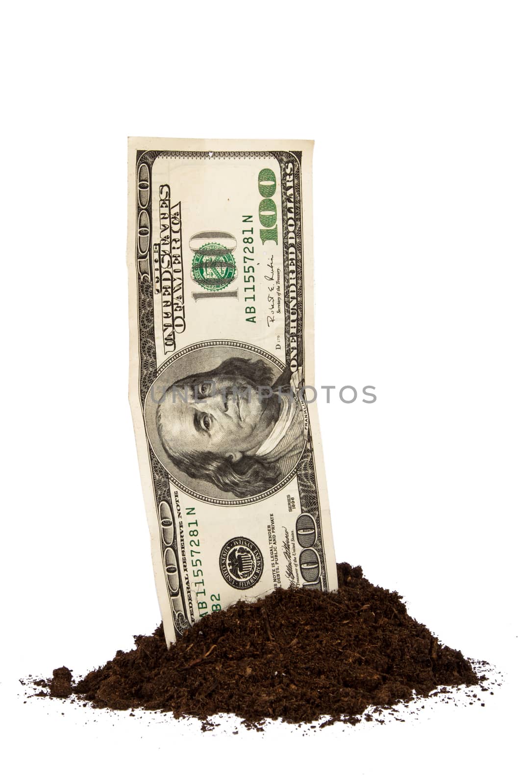 Pile of soil with one hundred dollar bill, isolated on white background.