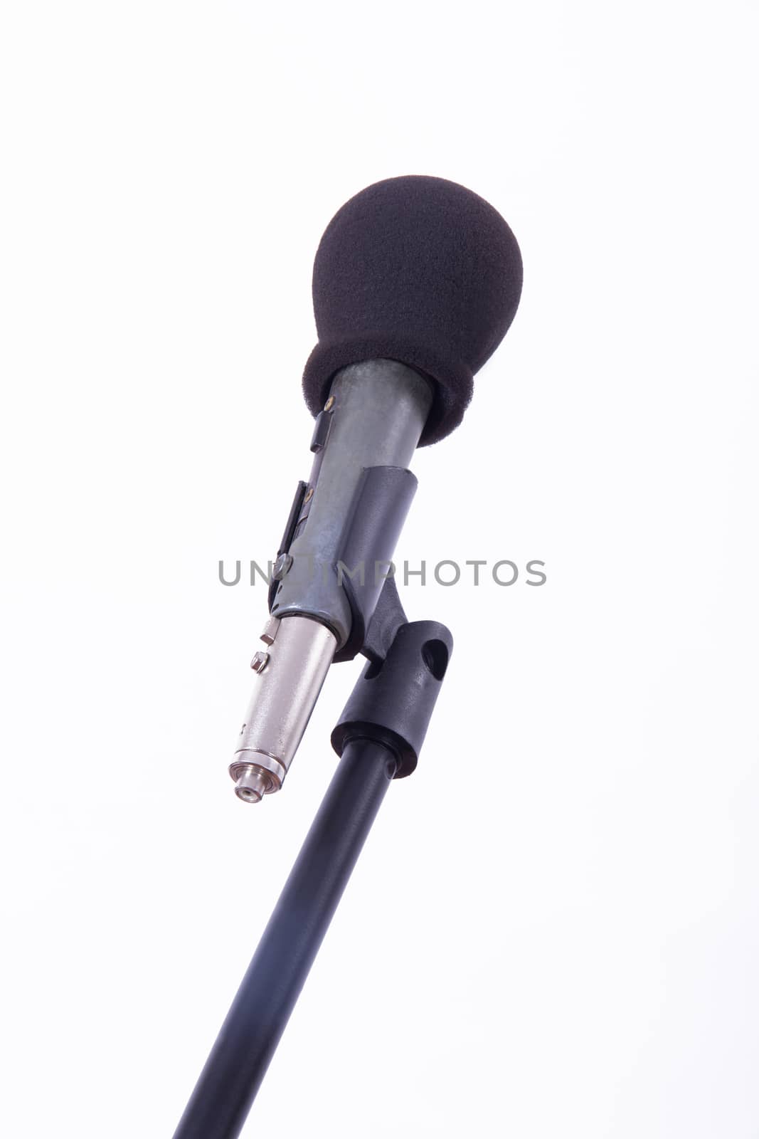 Black microphone on stand, isolated on white background.