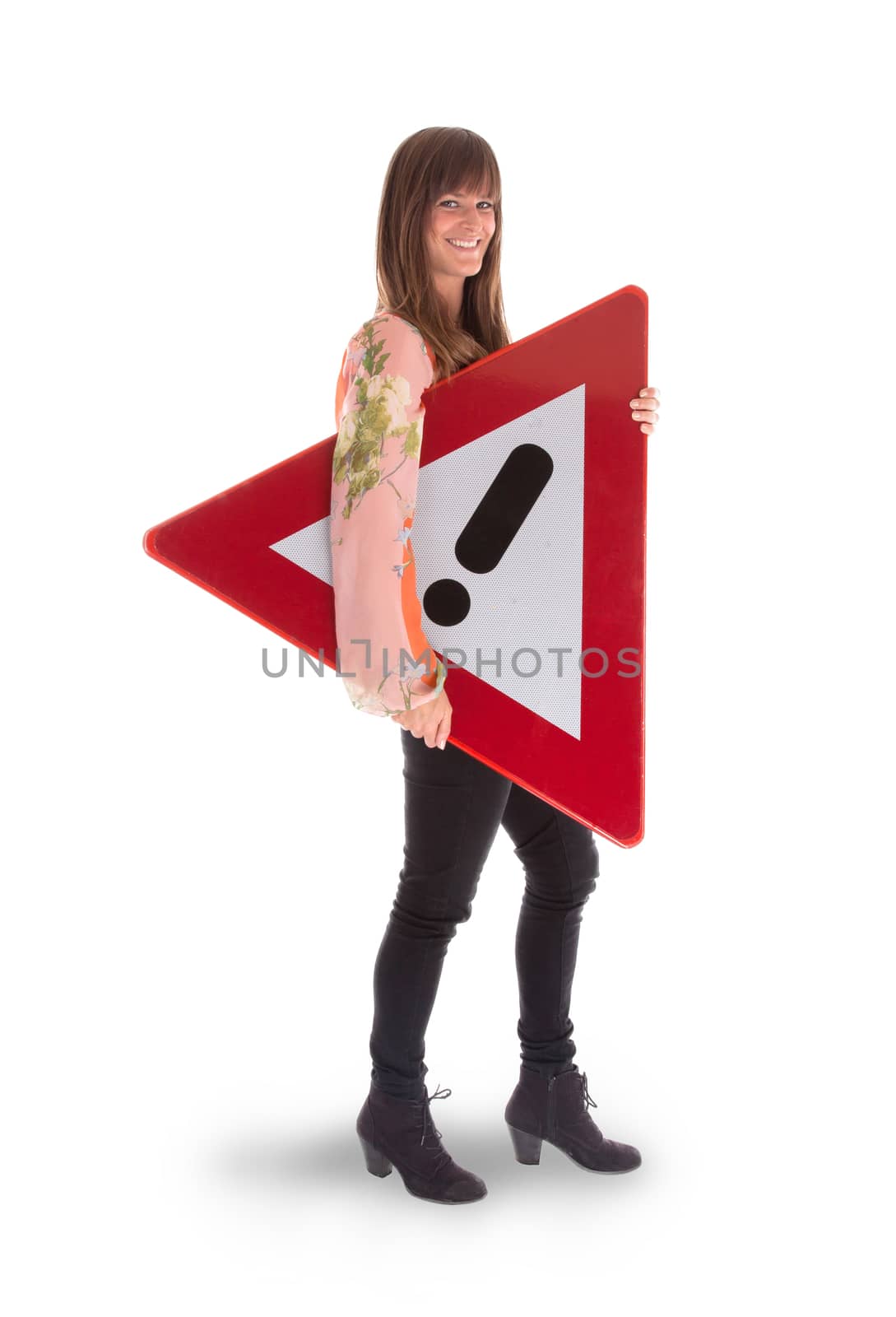 Concept of caution - Woman standing with caution sign by michaklootwijk