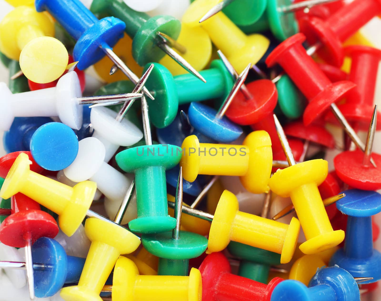 Colorful push pin or thumbtack macro background