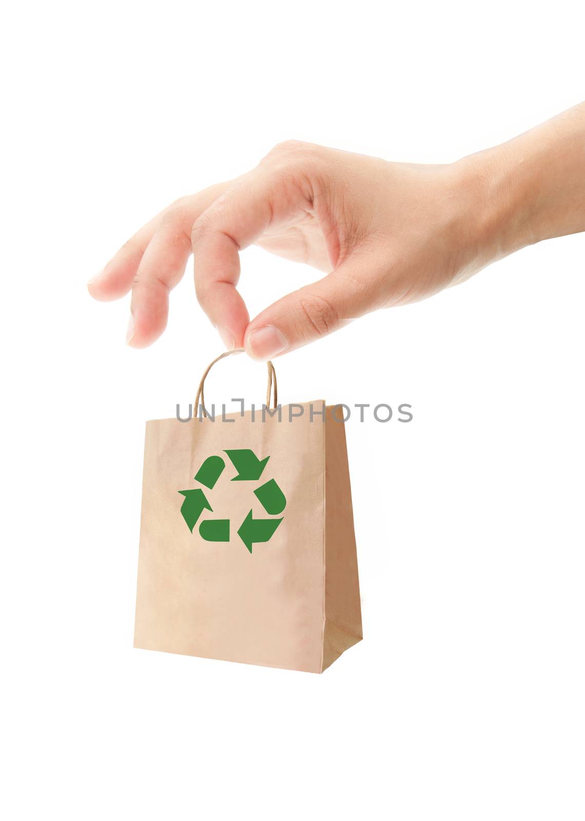 Hand holding a small paper bag with a recycling symbol