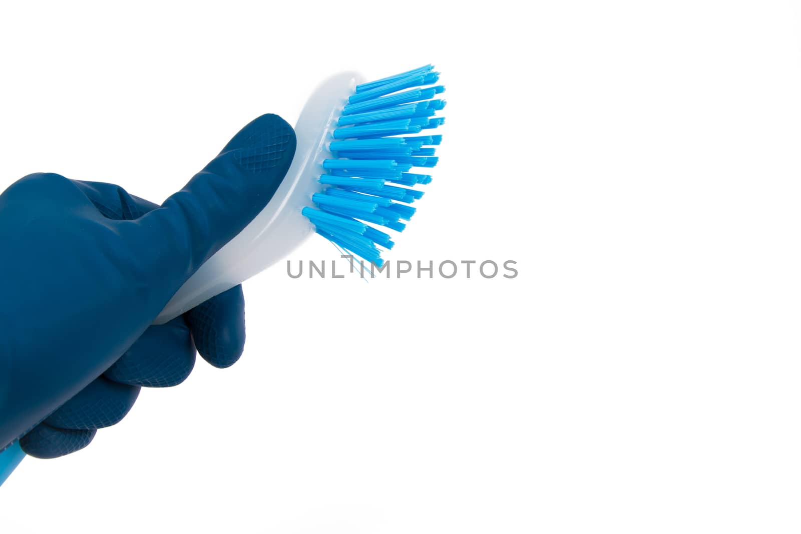Hand in rubber glove holding blue brush for cleaning, isolated on white background.