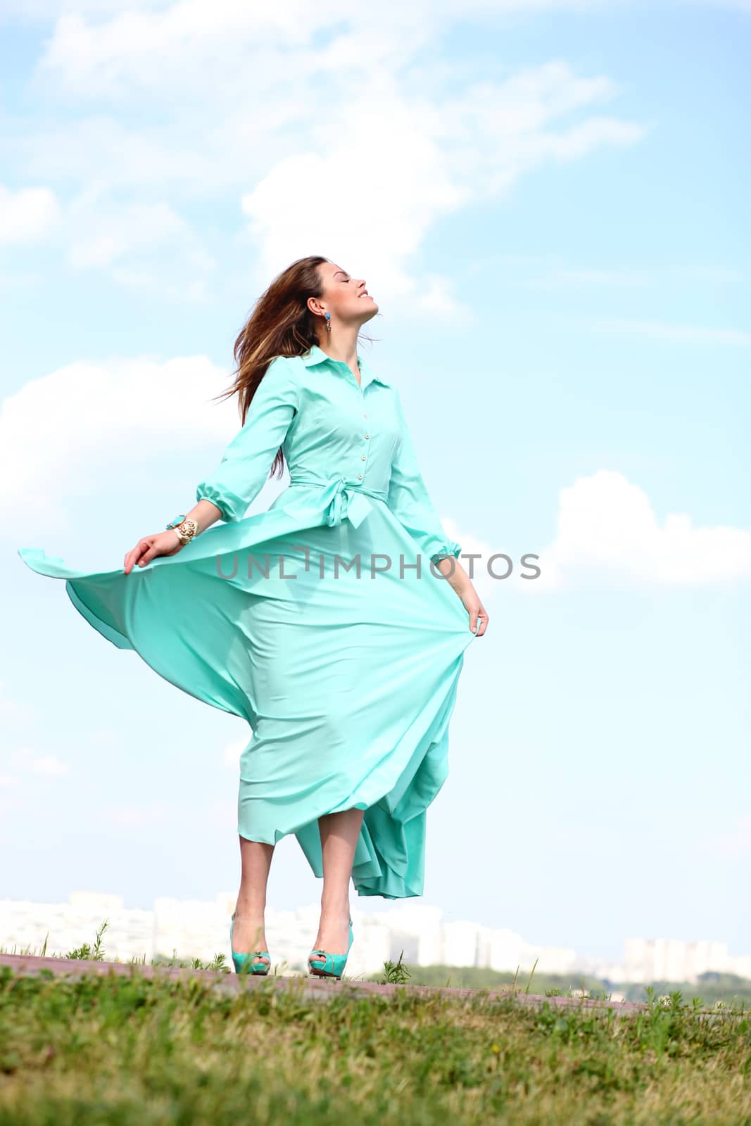 Portrait in full growth, attractive young woman in green dress