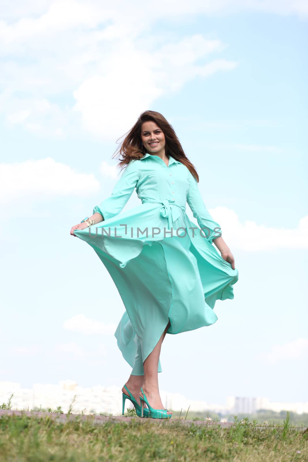 Portrait in full growth, attractive young woman in green dress