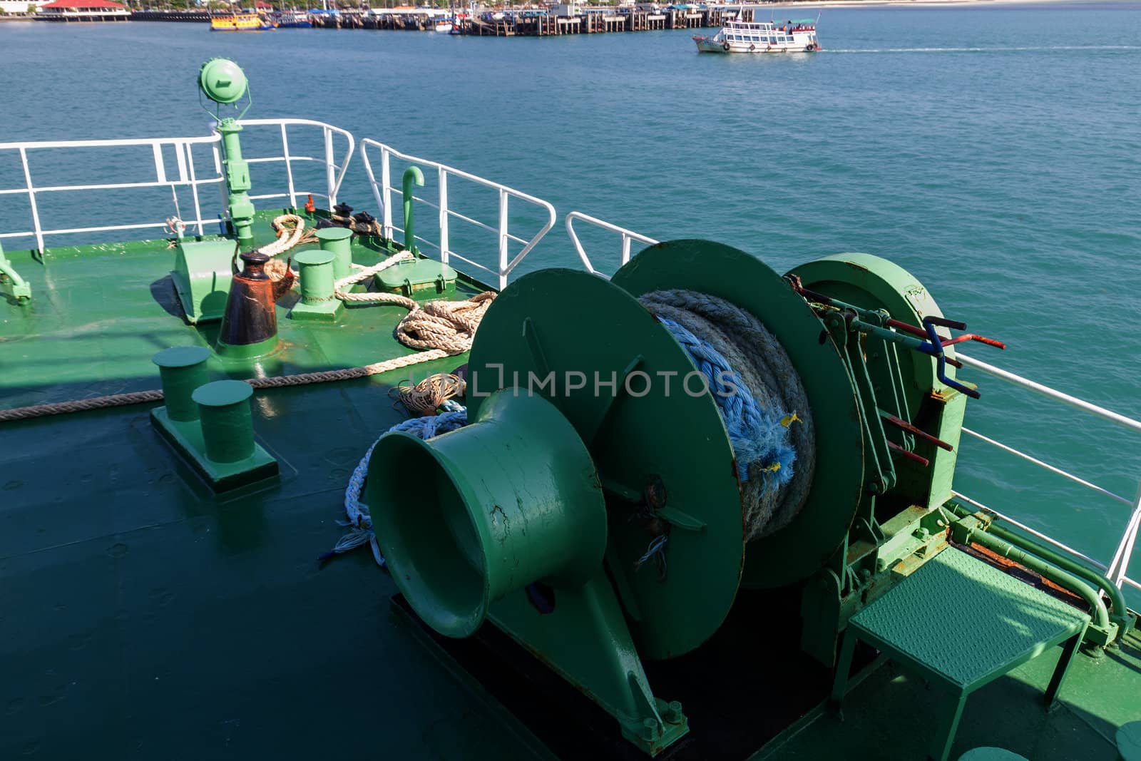 Winch with rope on ferry dropping anchor forward mooring station