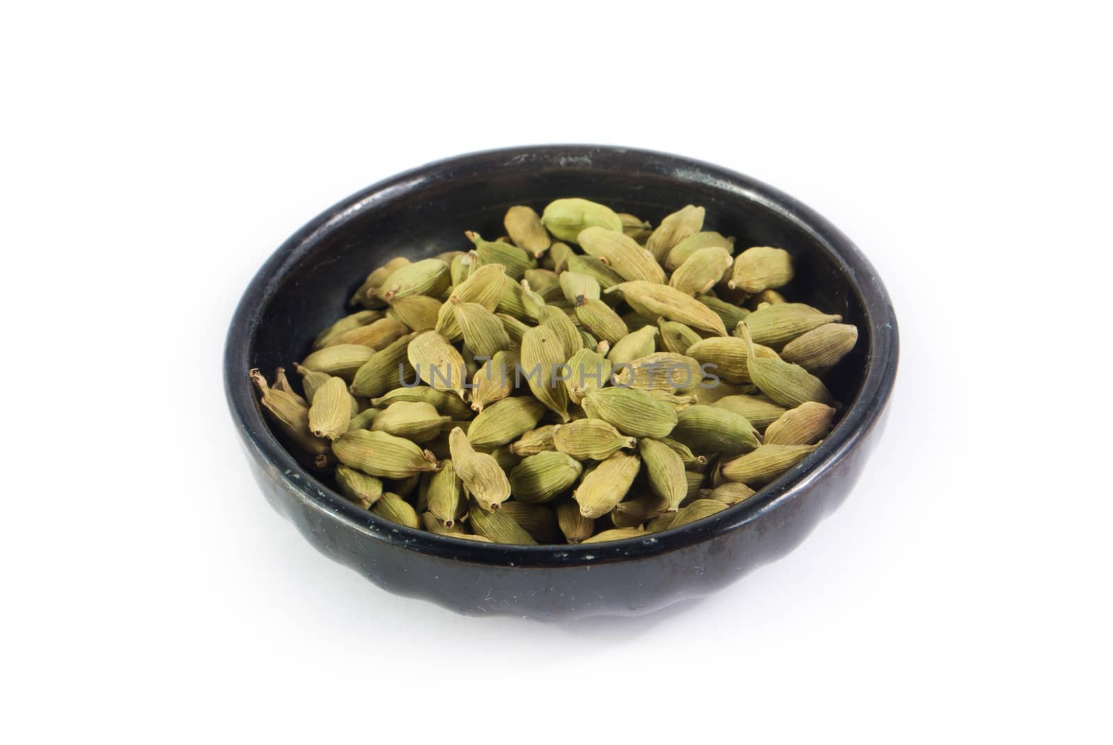 Pile of whole cardamom on white background