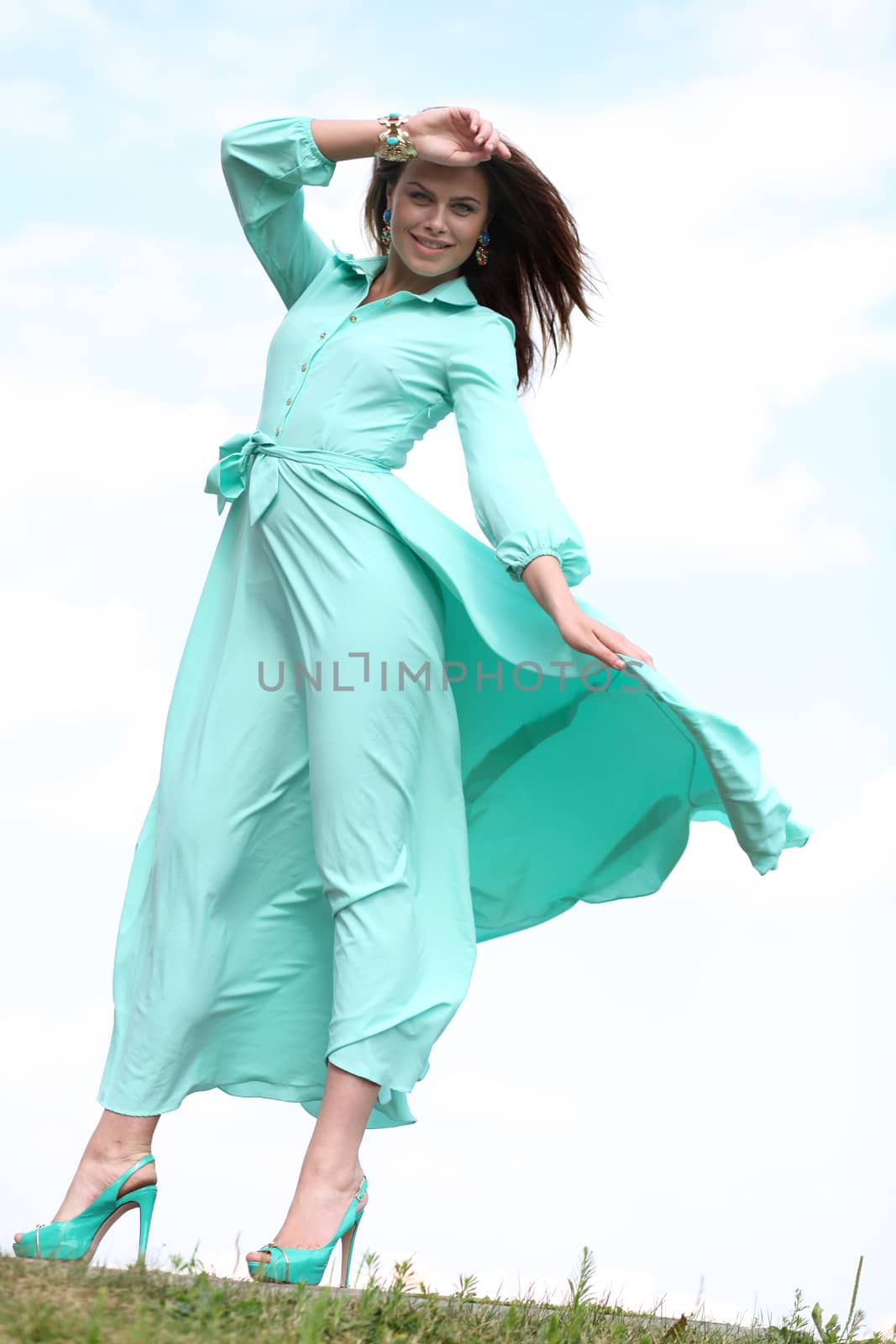 Portrait in full growth, attractive young woman in green dress