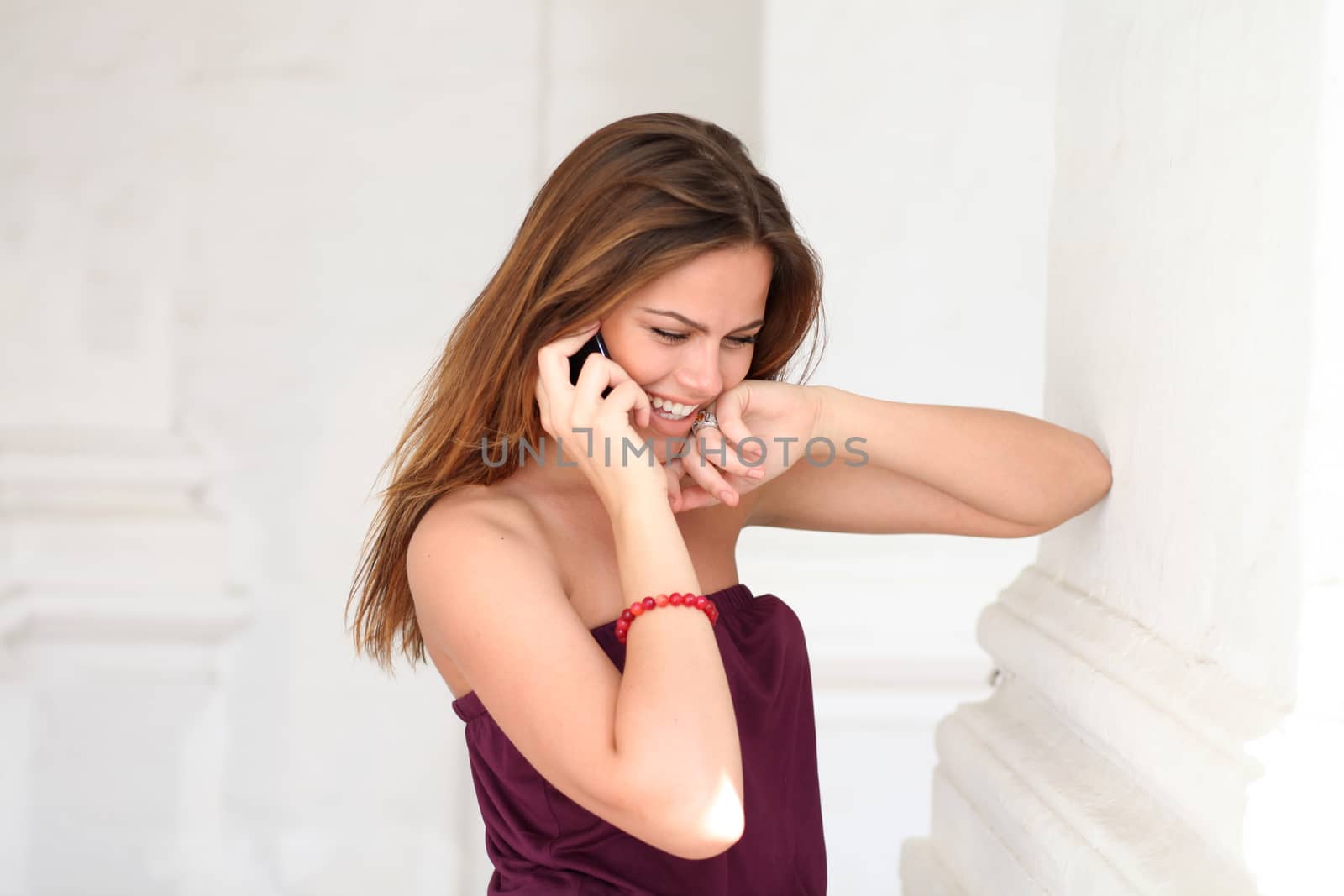 Young beautiful woman talking on cell phone