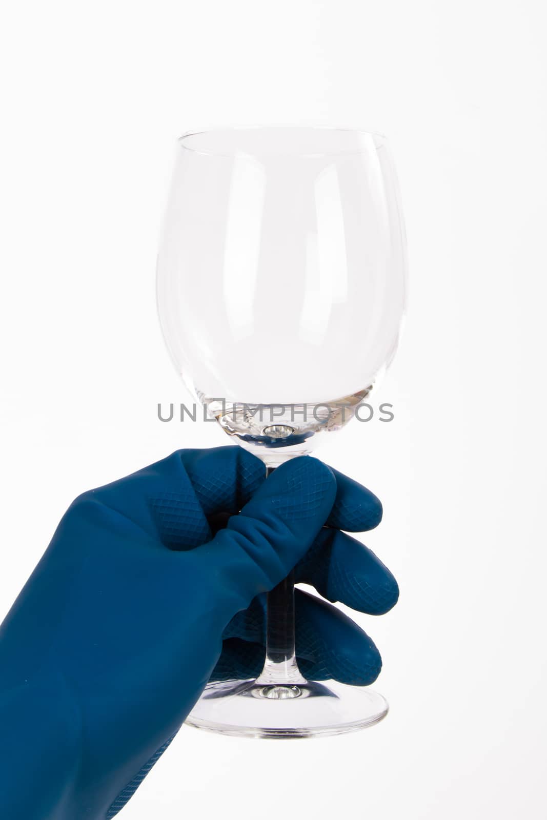 Hand with glove holding clean wine glass, isolated on white background.