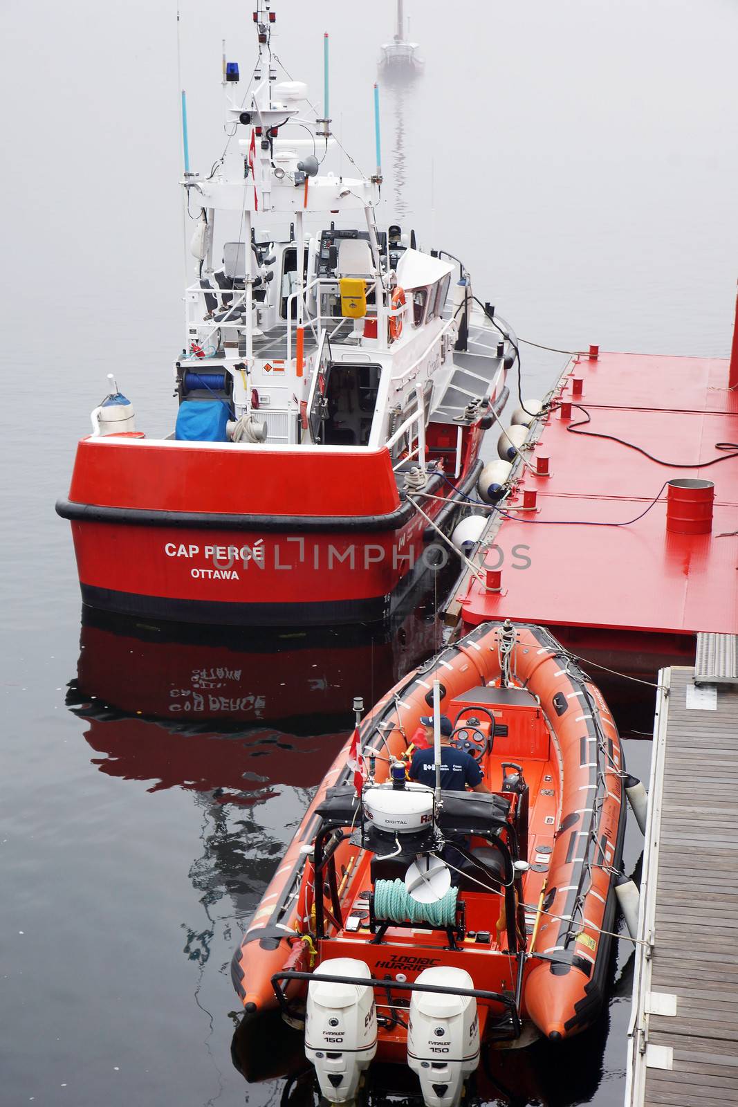 CANADA, QUEBEC, TADOUSSAC- AUGUST 8: Canadian coast guard vessel and zodiac docked at Tadoussac, Quebec, Canada on August 8, 2013. The Canadian coast guard is responsible for 2.3 million square nautical miles (8 million km2).