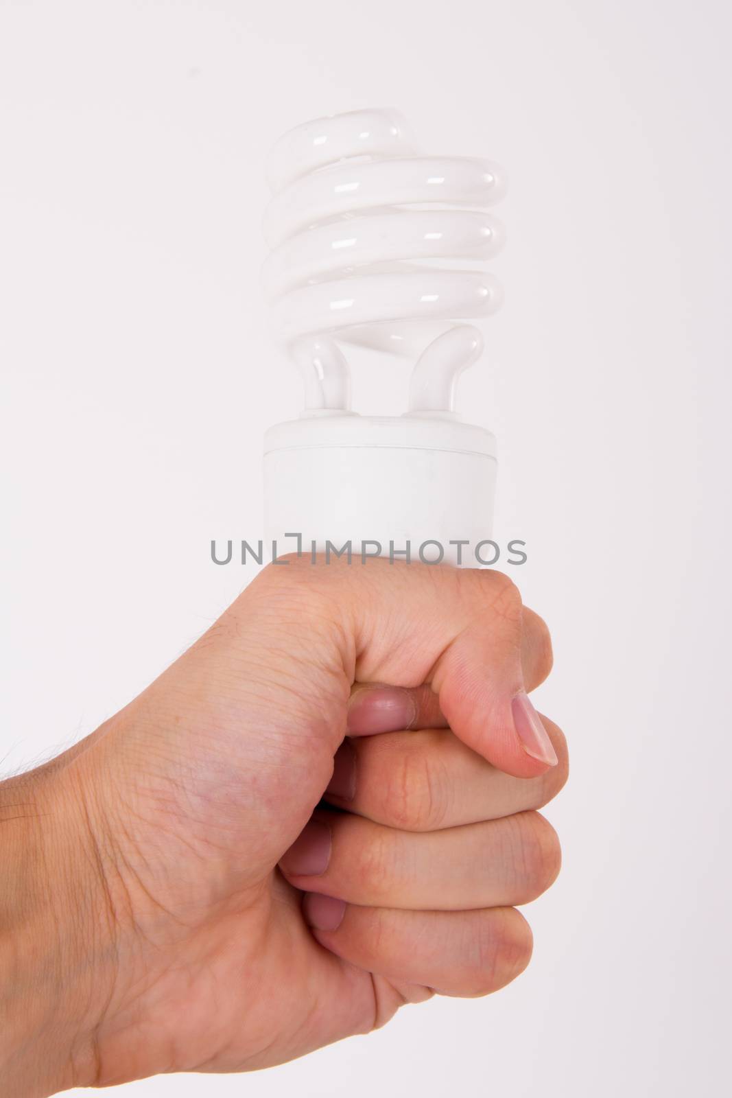 Affordable light bulb holding by male human hand on white.