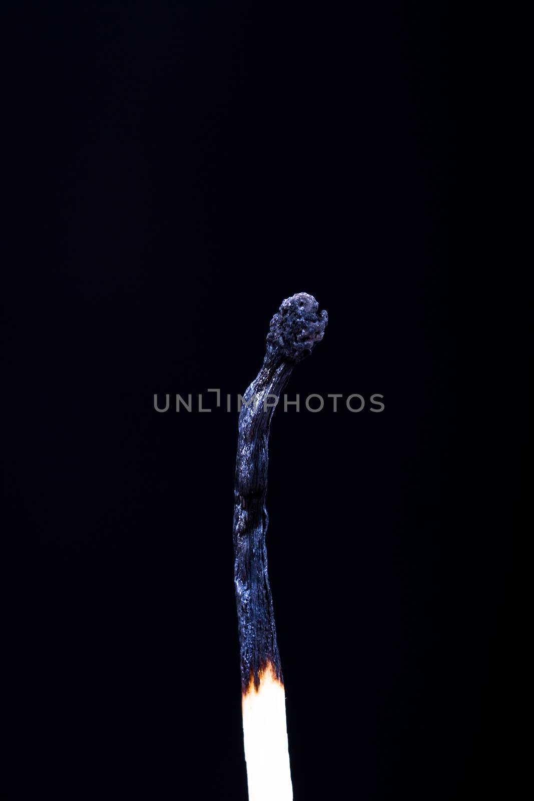 Burnt match on dark background.