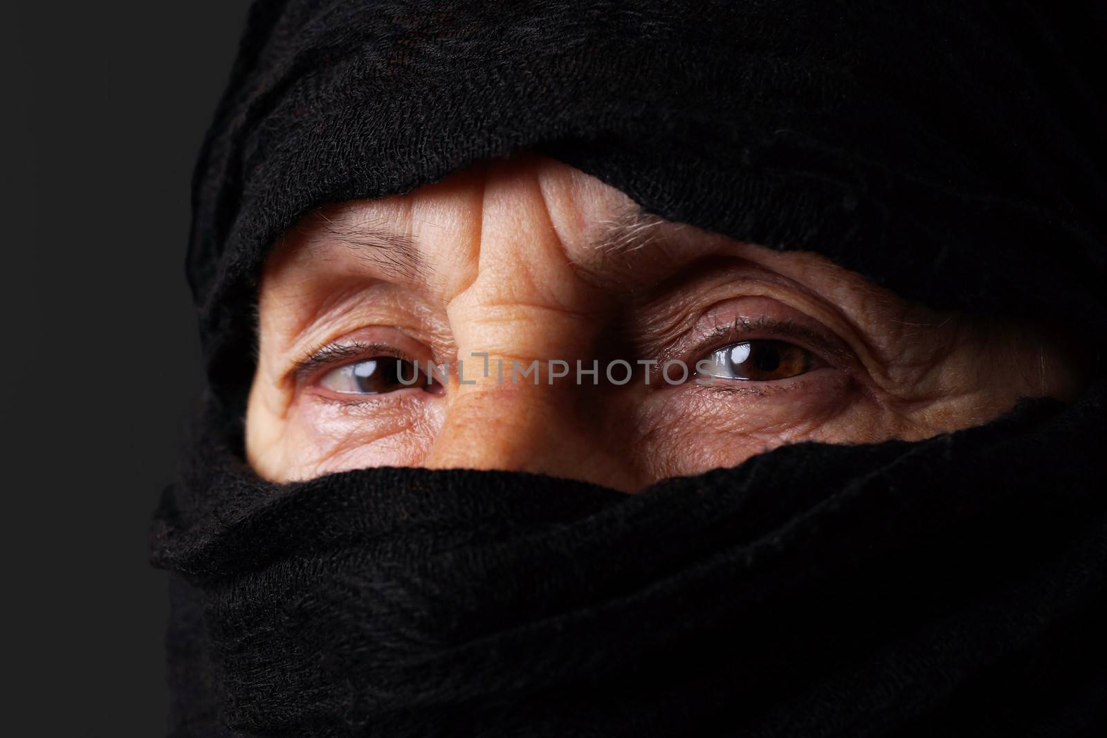 Eyes of senior muslim woman with niqab, looking at camera