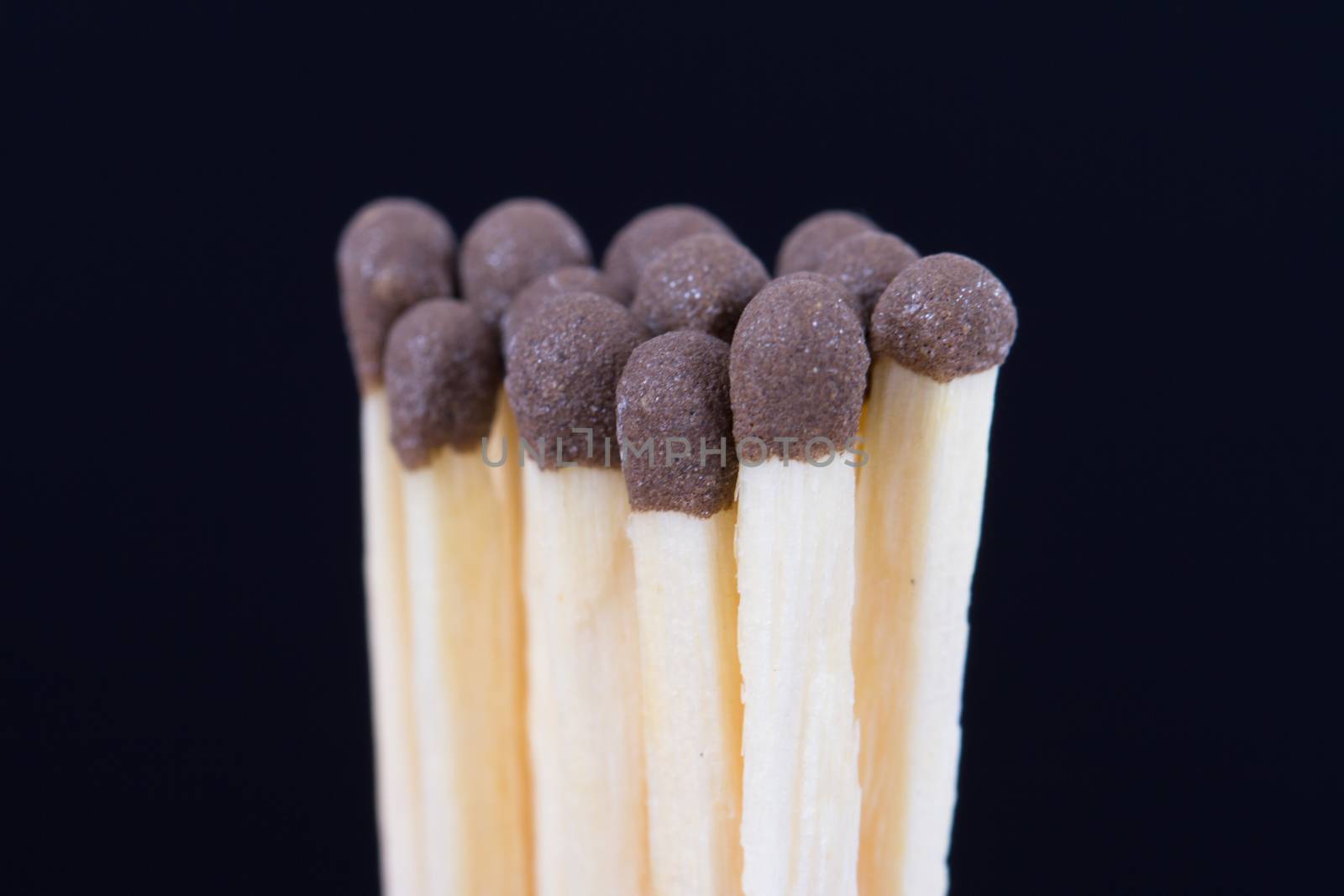 Group of healthy matches on dark background.