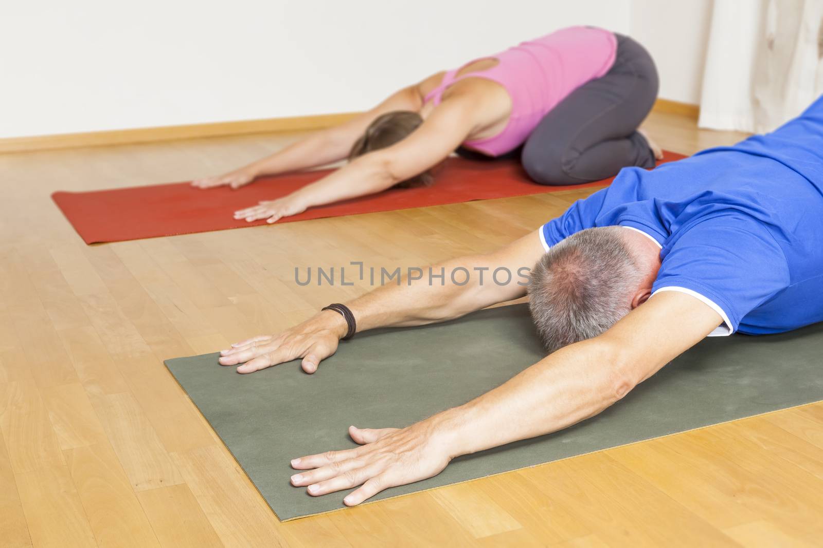 An image of some people doing yoga exercises