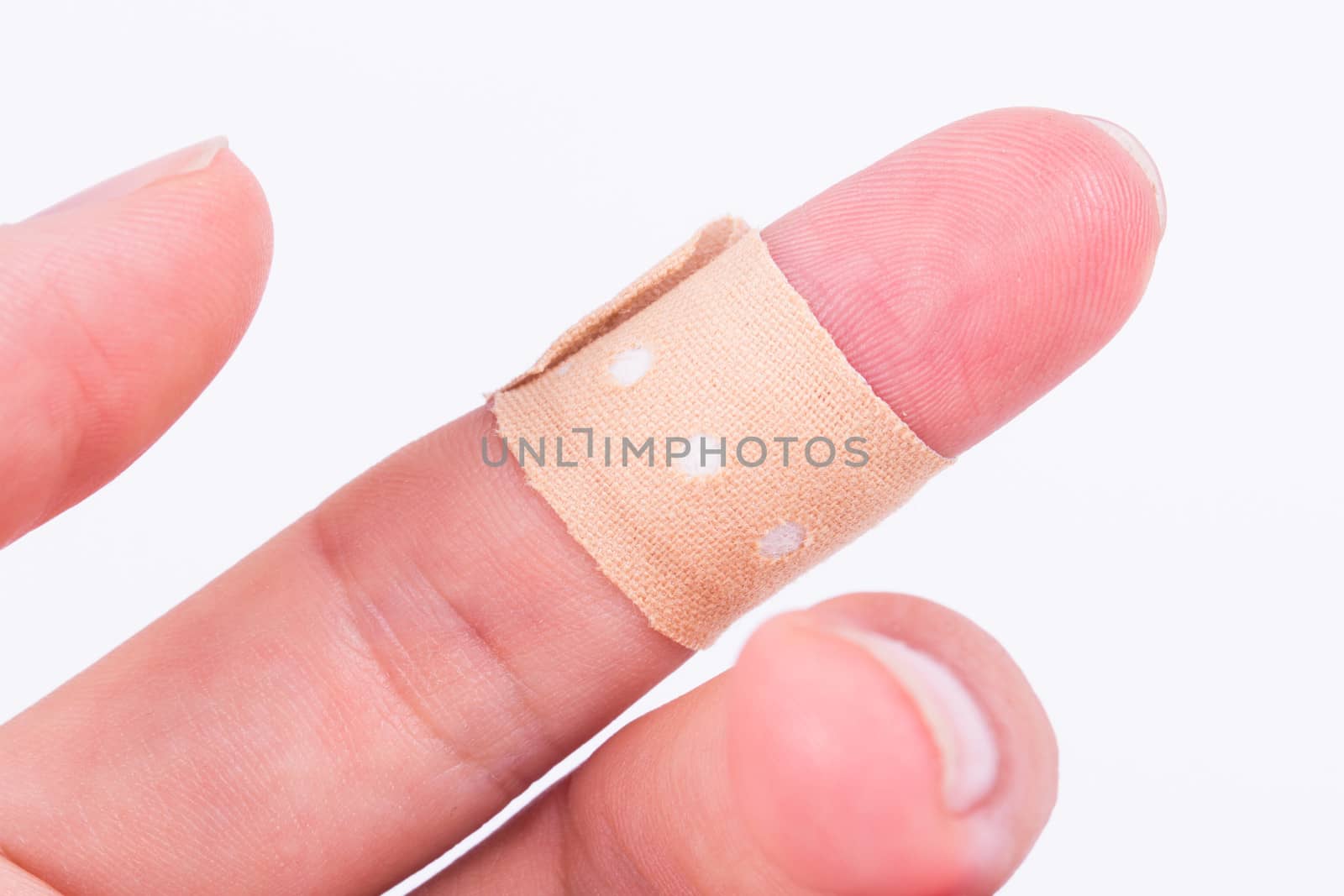Close up view of adhesive bandage, plaster on index finger, isolated on white background.