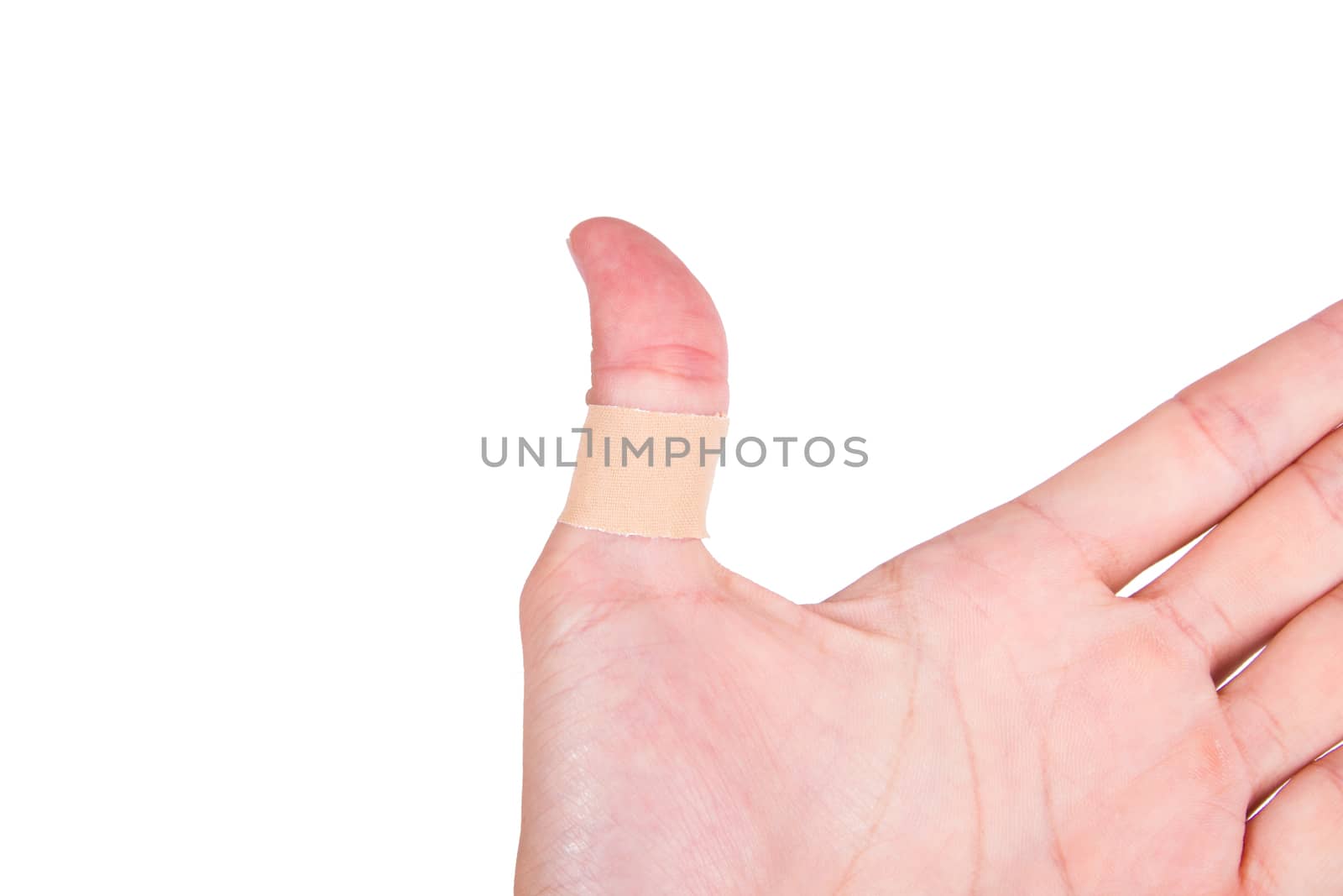 Adhesive bandage, plaster on thumb, isolated on white background.