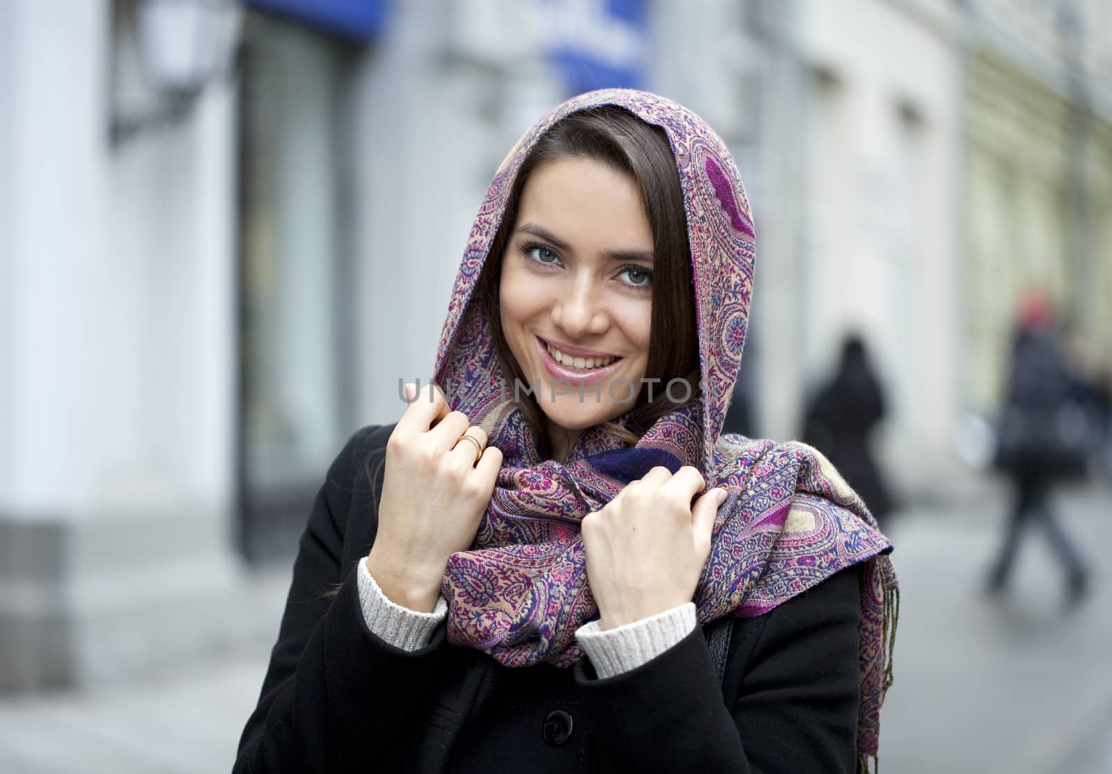 Portrait of young happy woman in red scarf