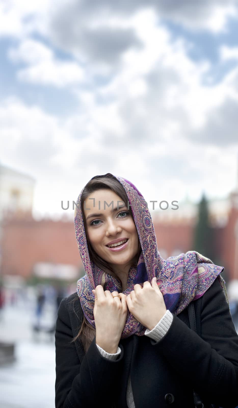 Portrait of young happy woman in red scarf