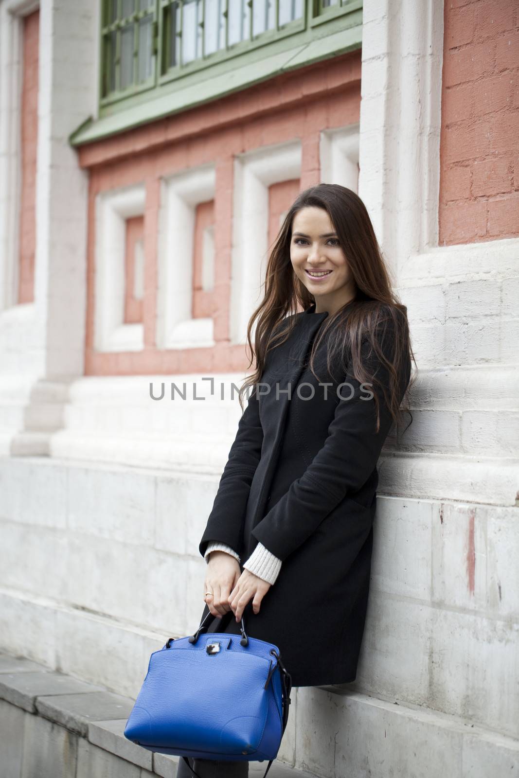 Portrait of beautiful woman in autumn street