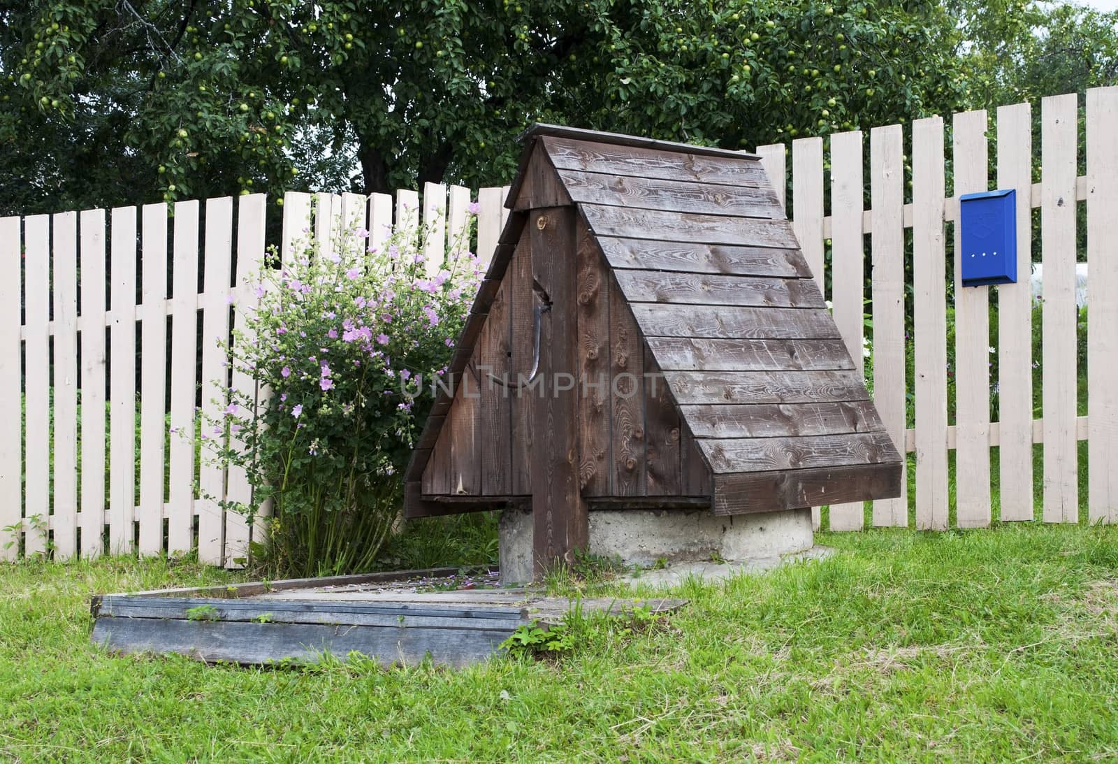 Country wooden well near the house