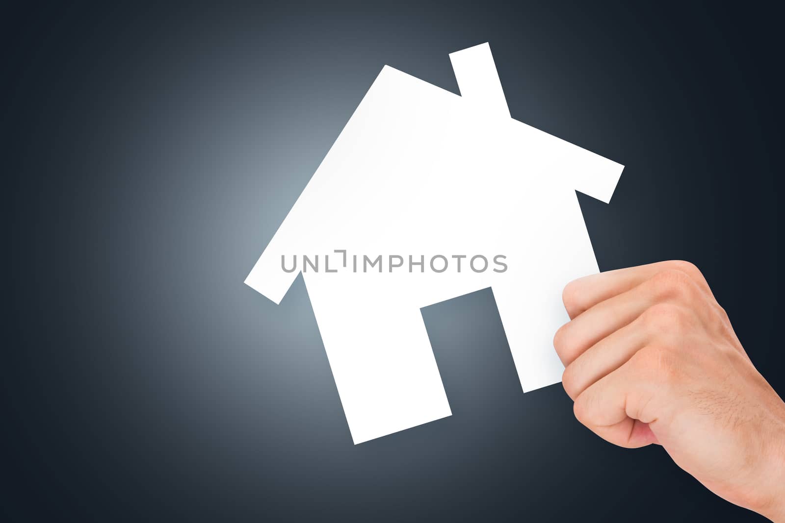 Hand holding white, empty, blank real estate cardboard on dark background.