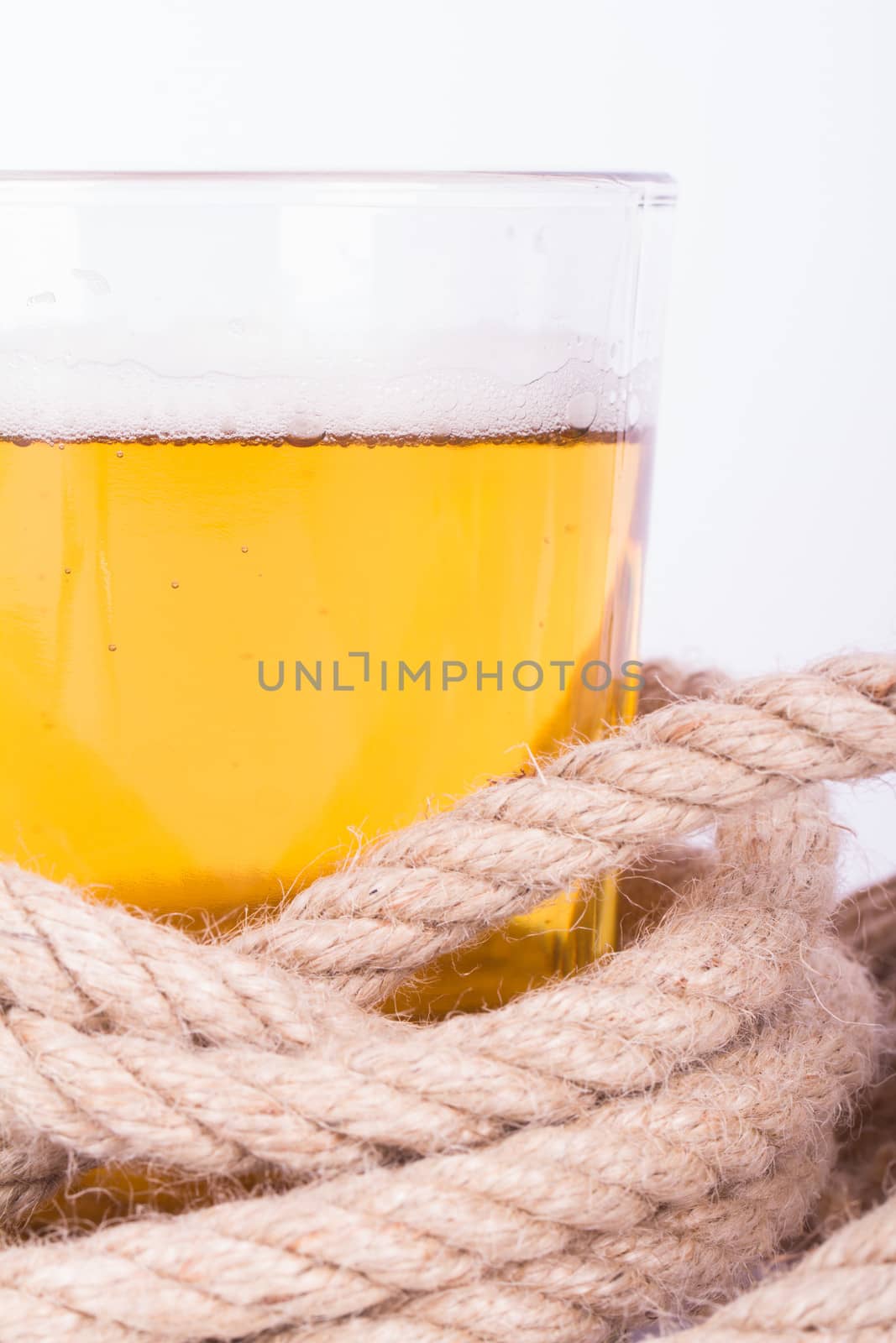 Full of beer glass and rope, isolated on white background.