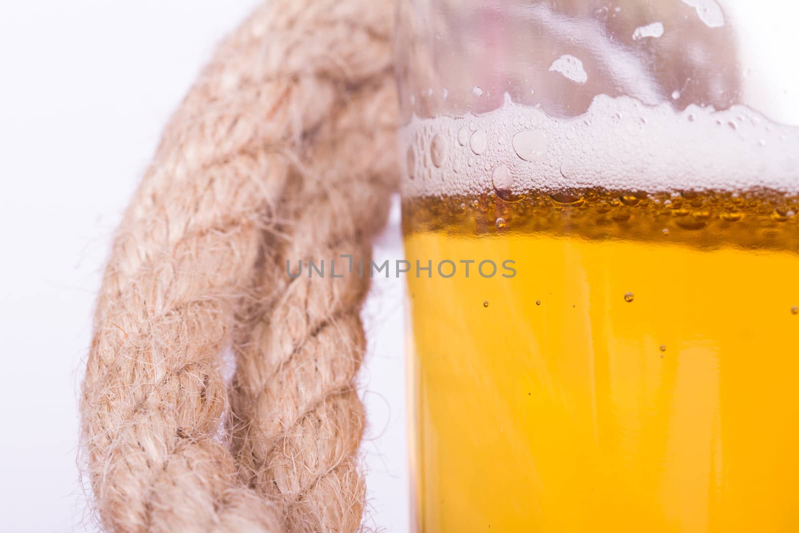 Close up view, full of beer glass and rope, isolated on white background.