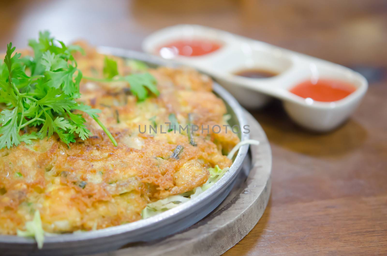 chinese omelet served with chili sauce and vegetable 