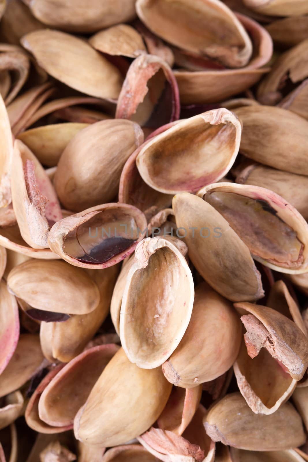 Heap of pistachio nutshells background.