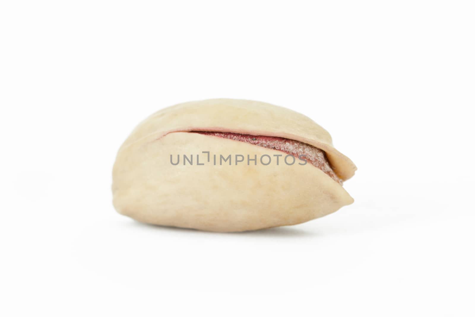 Single pistachio nut, isolated on white background.