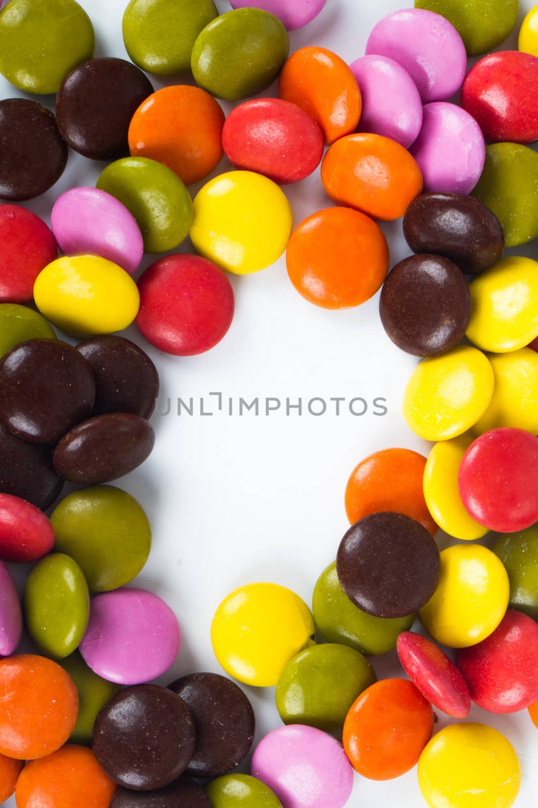 Colorful sugar candies with copy space, isolated on white background.