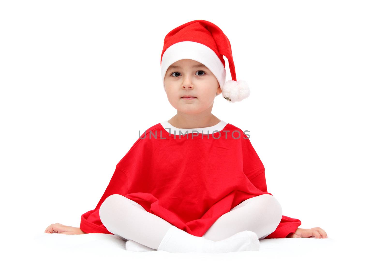 child in santa claus hat sitting on white by NikolayK
