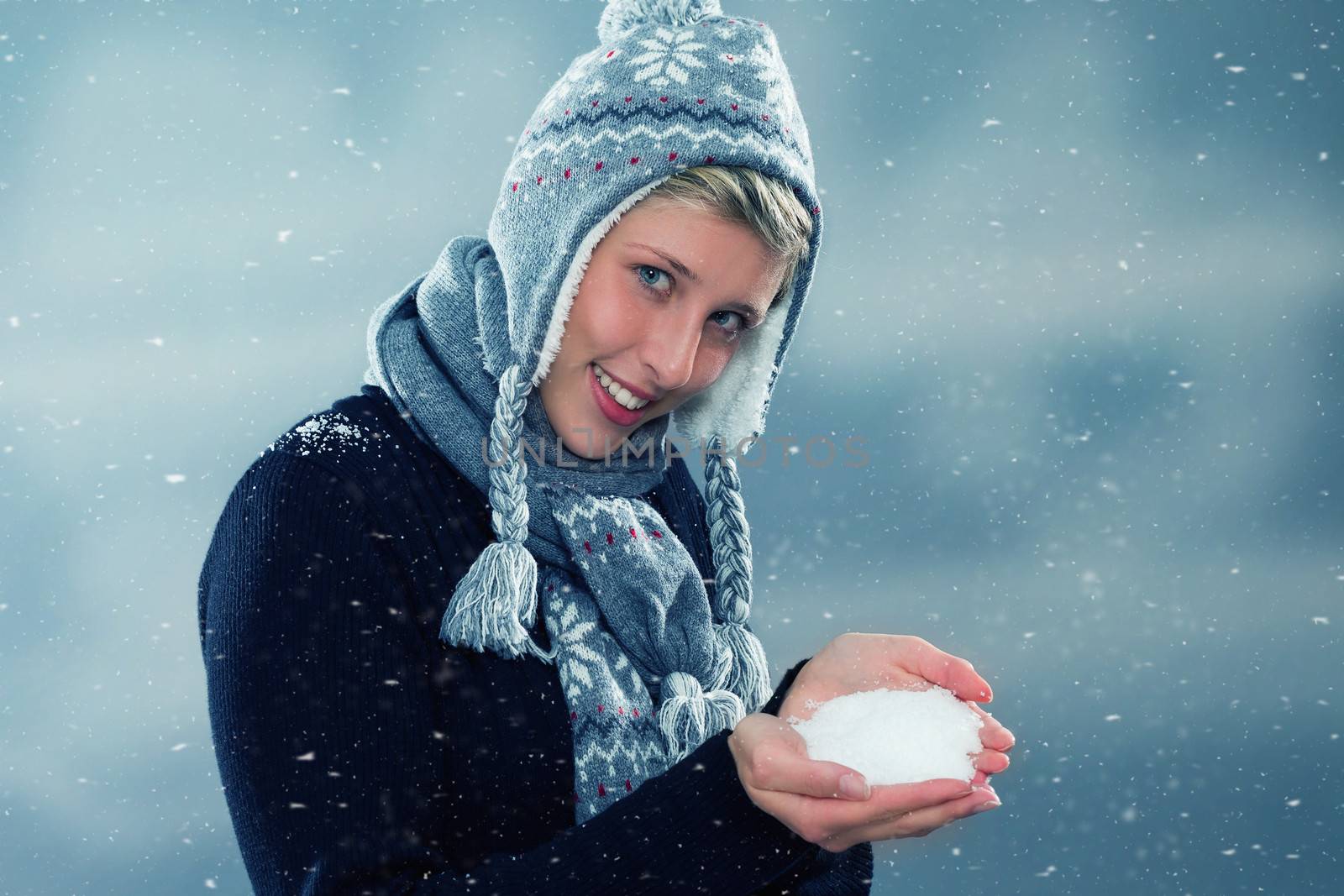 happy young woman presenting hand full of snow  by RobStark