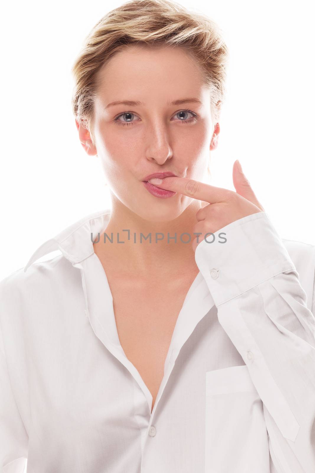 young blonde woman sucking her finger on white background