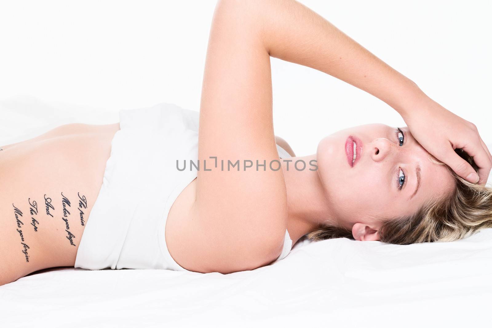 sensual woman in bed on white background