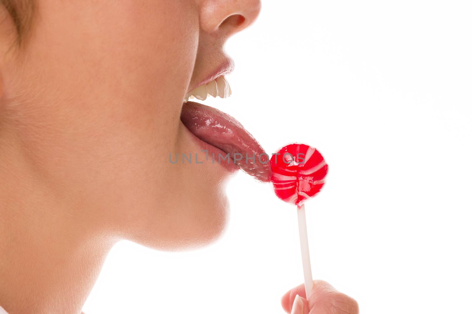 closeup tongue licking lollipop on white background