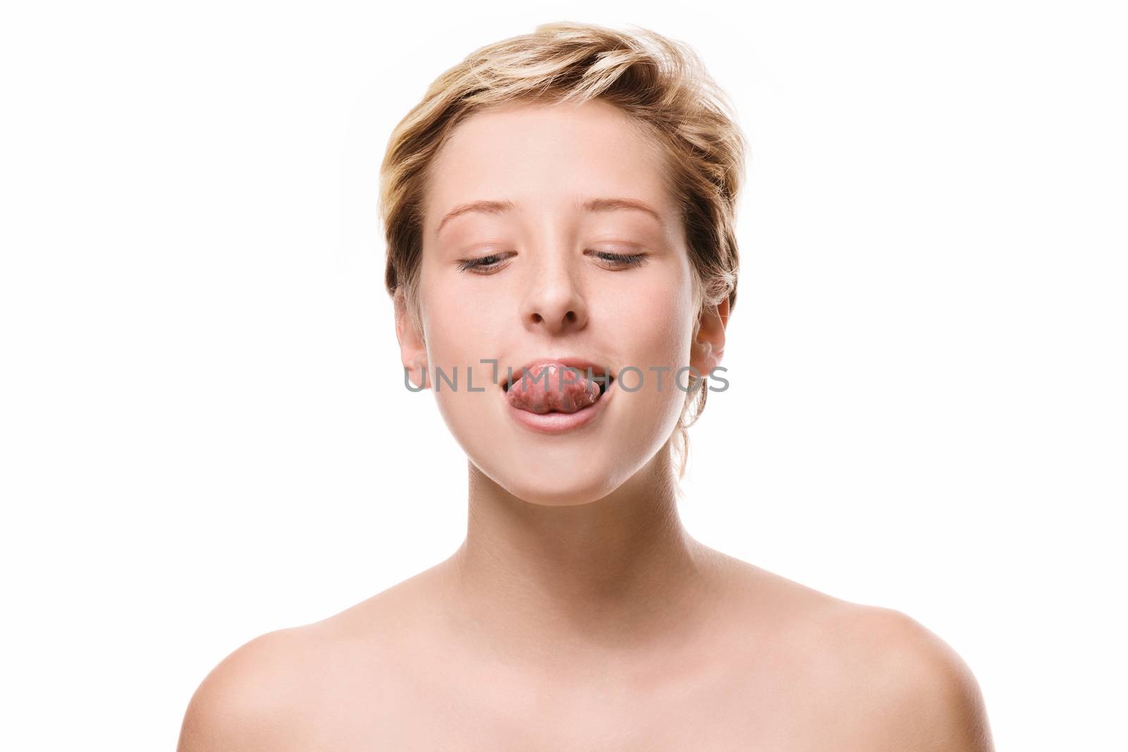 cute woman trying to reach her nose with her tongue on white background