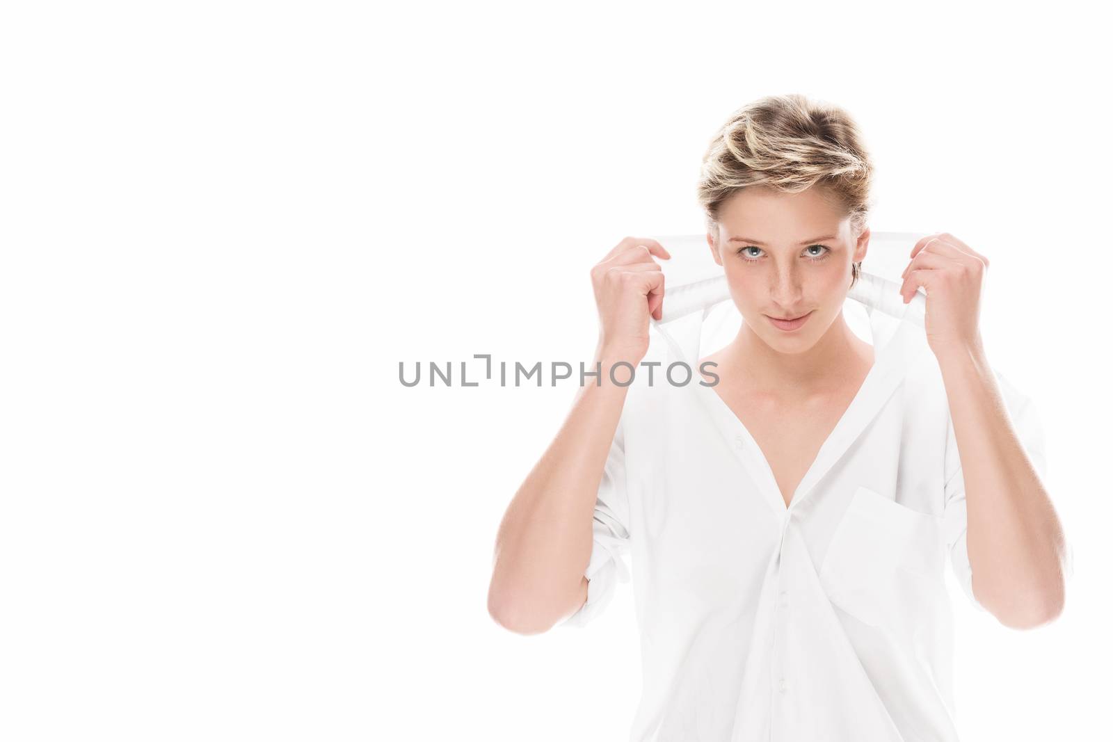 smiling young woman holding the collar of her button down shirt on white background