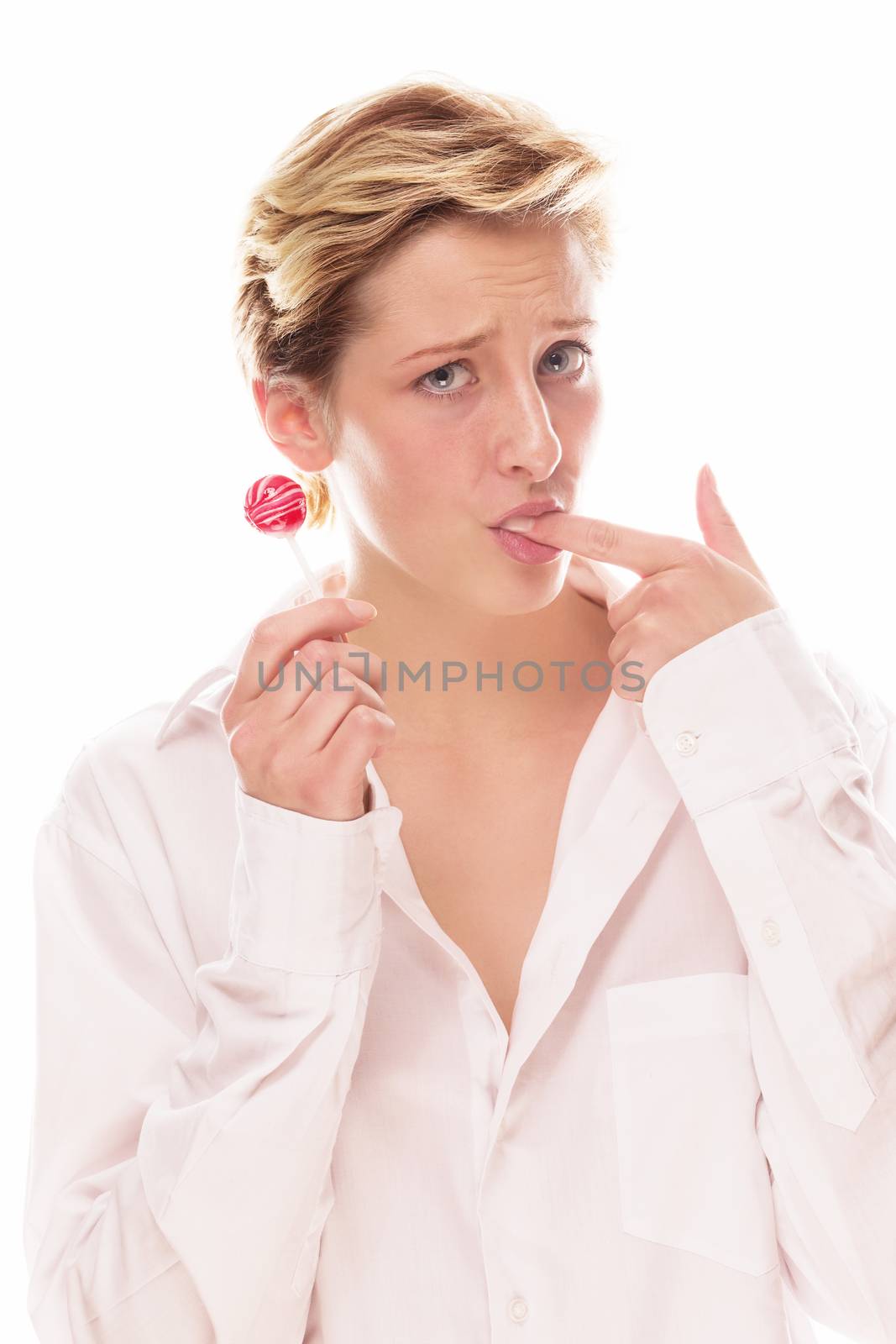 young woman holding lollipop sucking her finger on white background