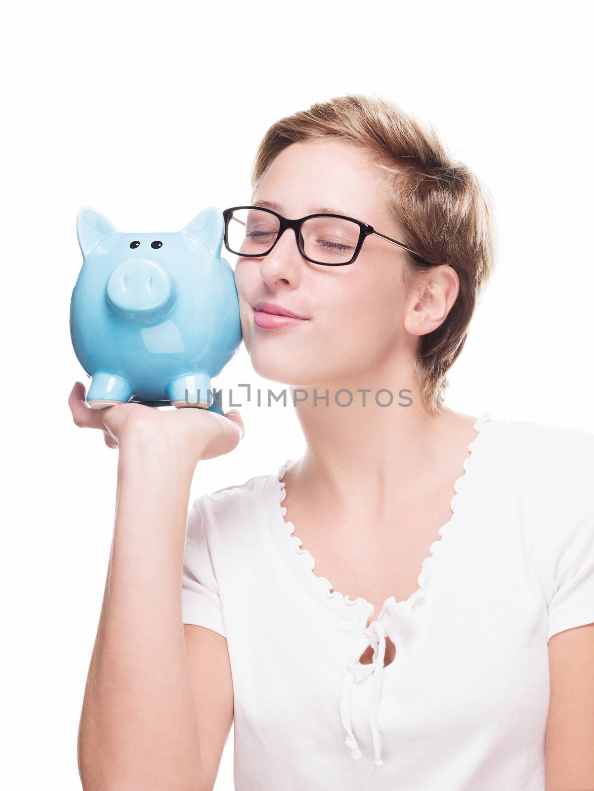 cute blonde woman cuddling with a piggy bank on white background