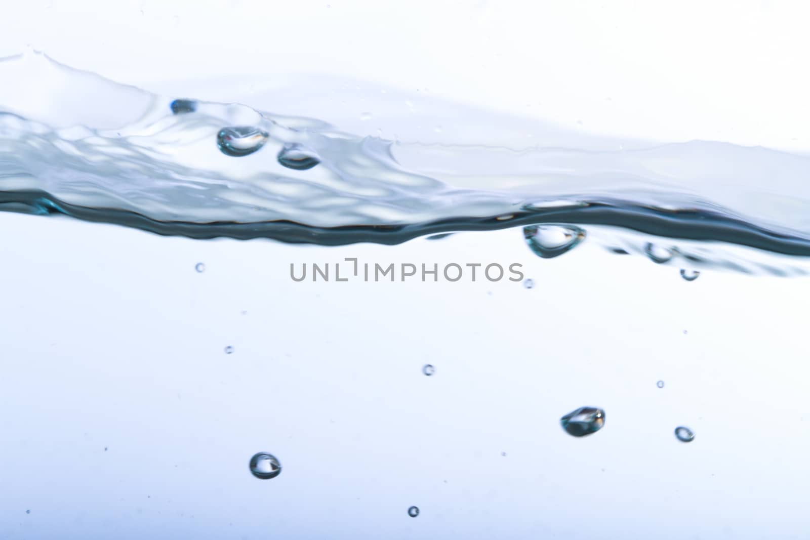 Close up view of water splash with big bubbles, isolated on white background.