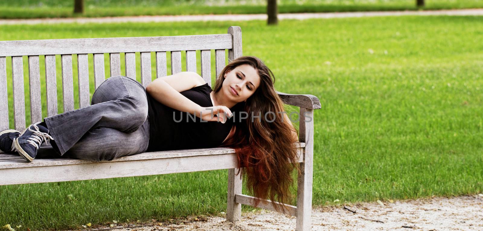 pretty young girl couch on a bench