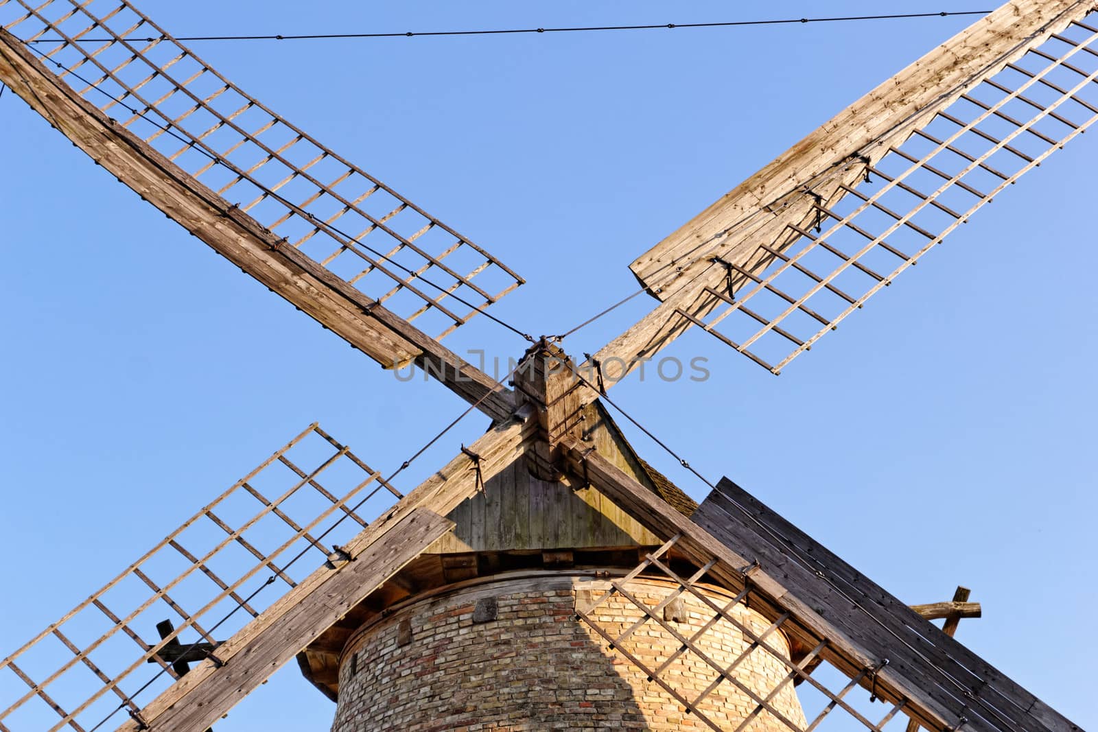 Old wooden windmill against the blue sky