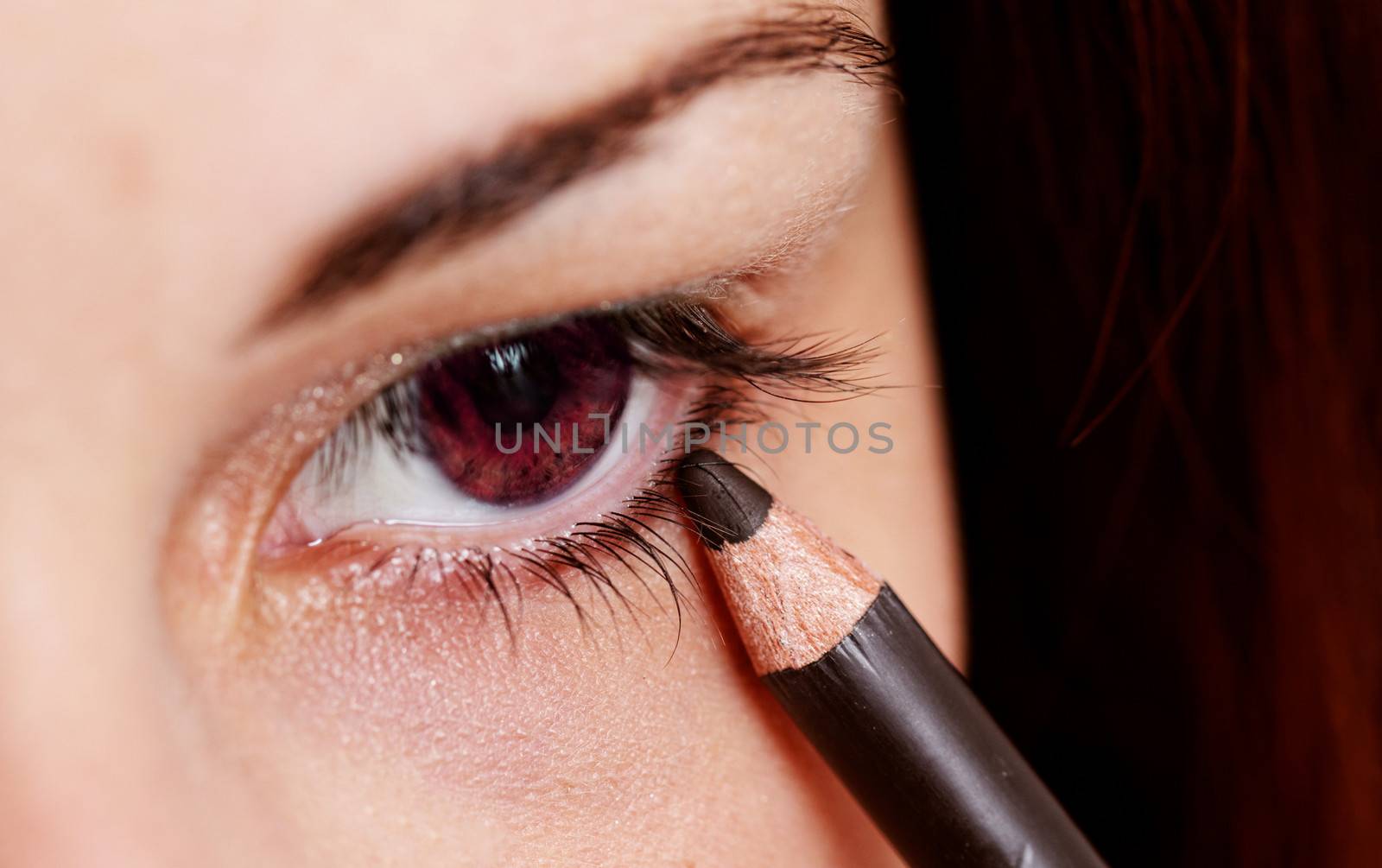 beautiful woman wearing makeup for red eyes with eyeliner