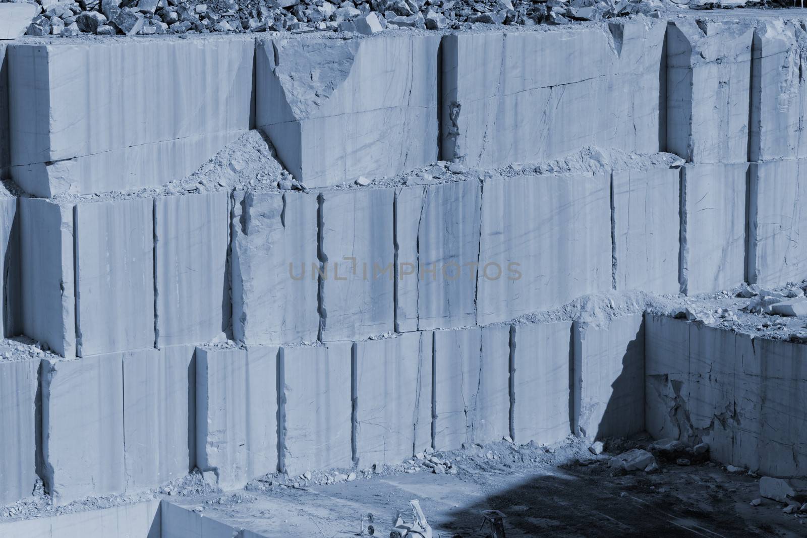 Detail of huge Thassos white marble quarry (mine) with grabber (color filtered photo) abstract